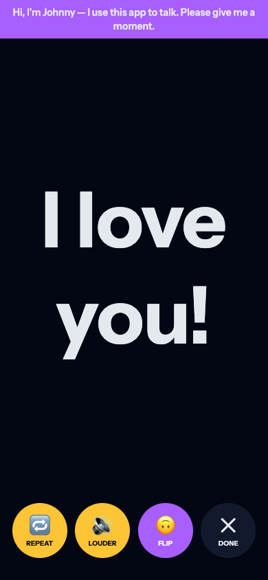 The Tadamo SHOW screen displaying 'I love you!' in huge letters, with a banner reading 'Hi, I'm Johnny — I use this app to talk. Please give me a moment.' and Repeat, Louder, Flip and Done buttons.